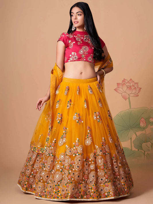 Impressive Yellow Mirror Work Net Reception Wear Lehenga Choli - Zeel Clothing